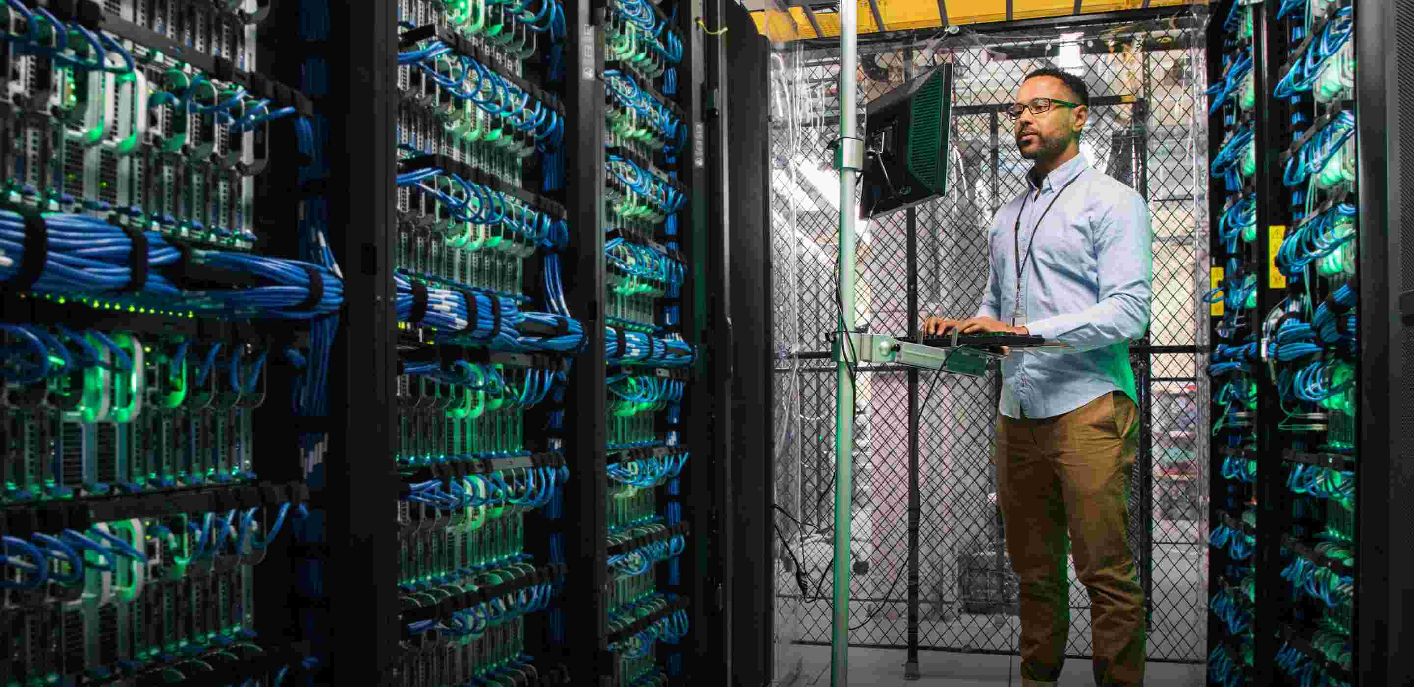 technician using computer in server room