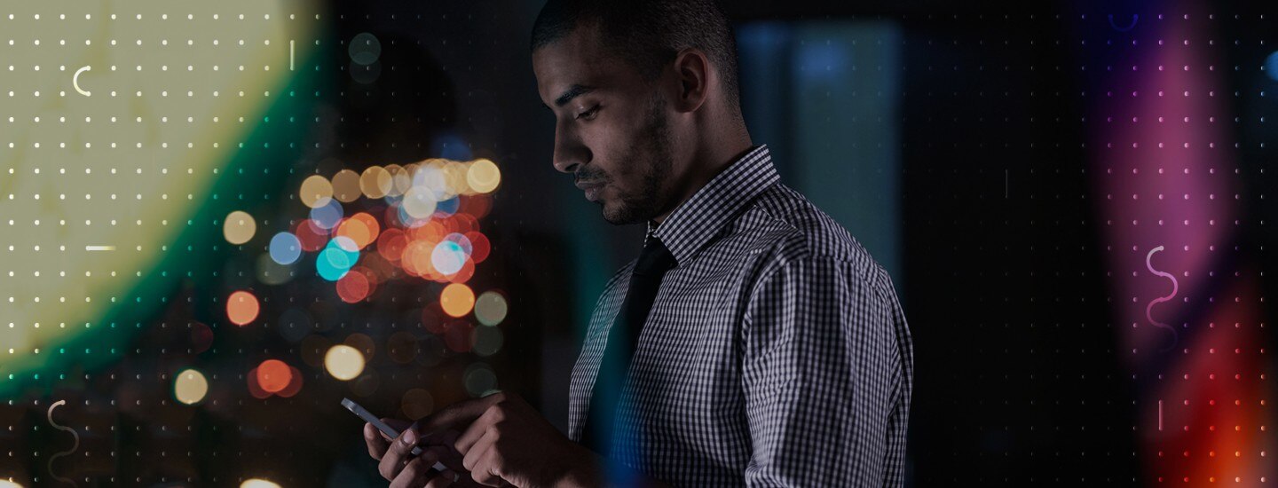 A man looking down at his phone in his hand
