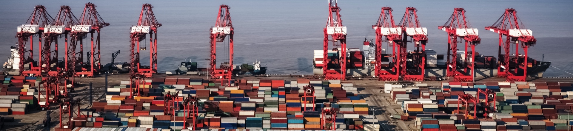 Stacked storage containers on a harbor next to the sea