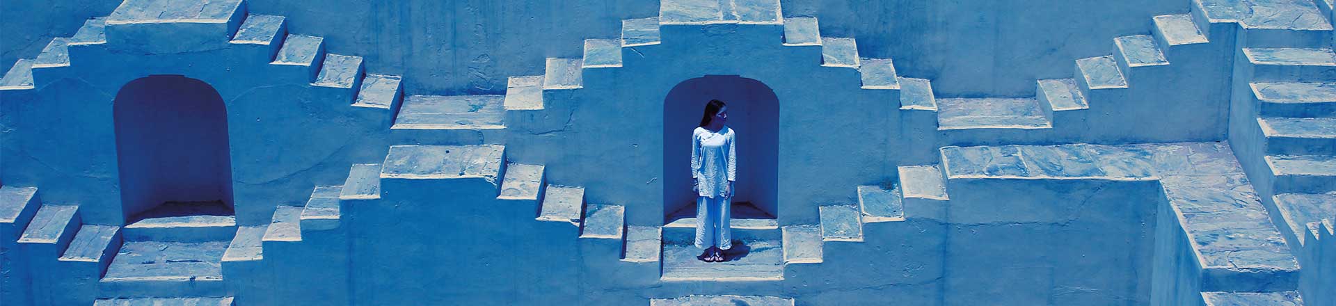 Lady dressed in white in front of the stairways