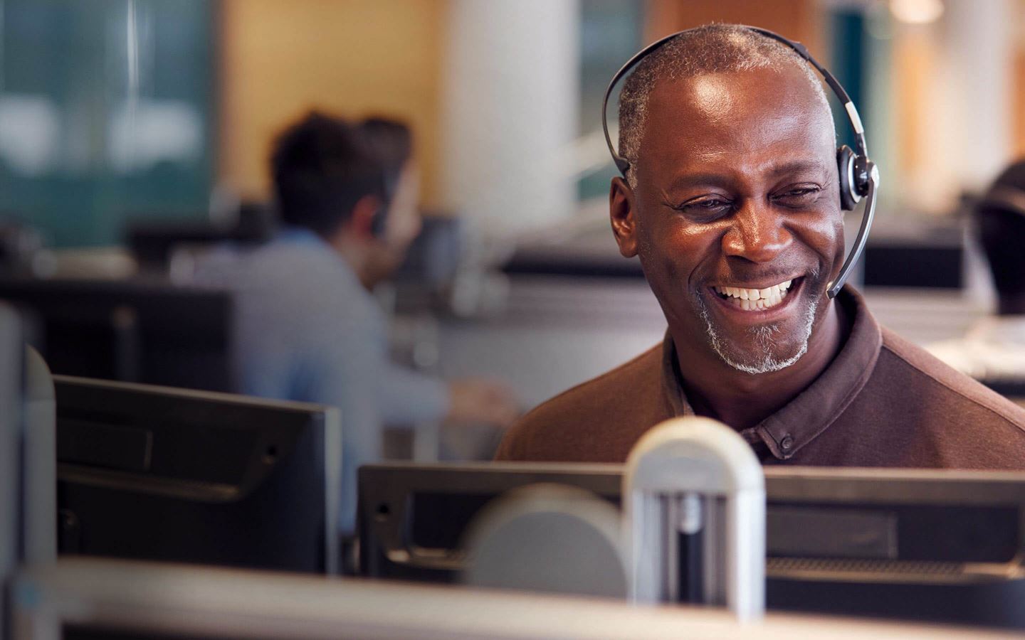 A man with headsets smiling