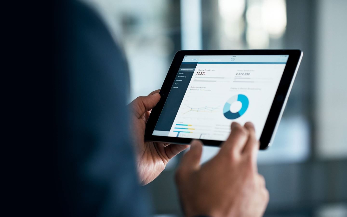 Hand on a tablet with data