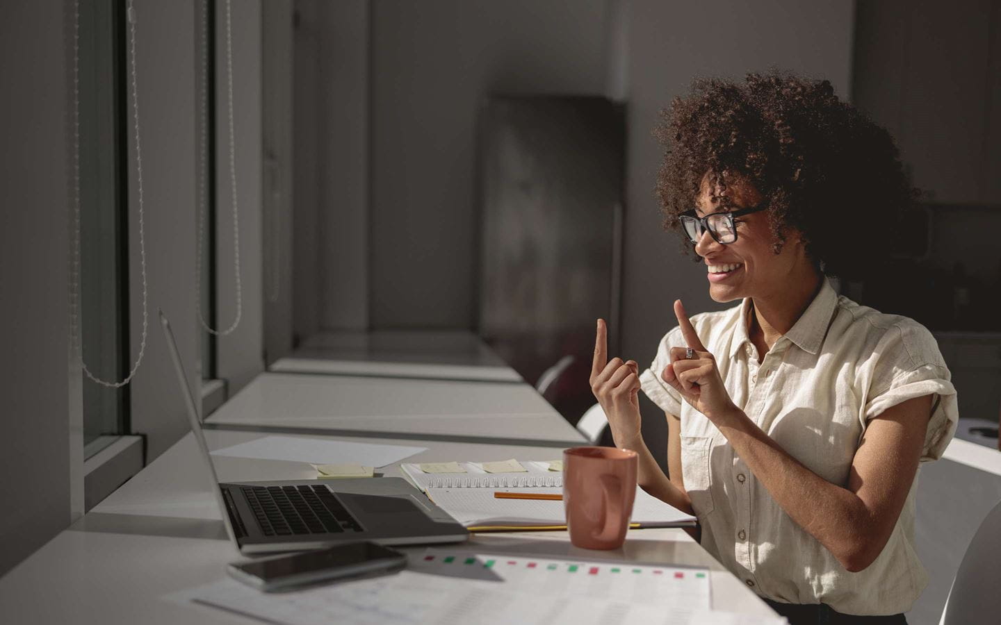 A woman communicating with laptop