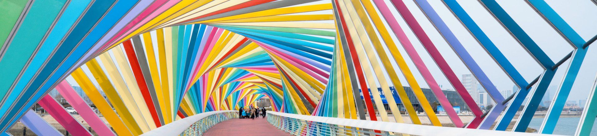 People walking on a colourful bridge