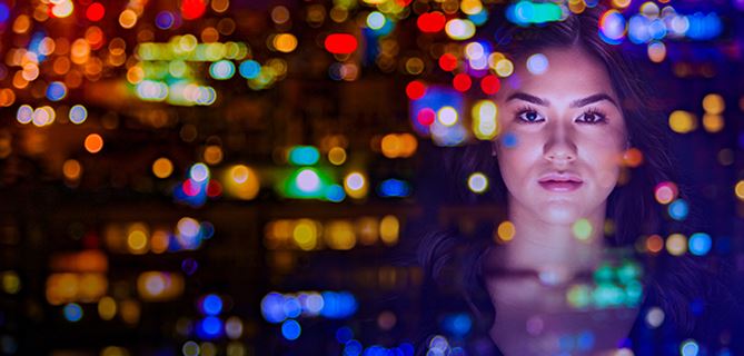 Lady looking at a colorful screen