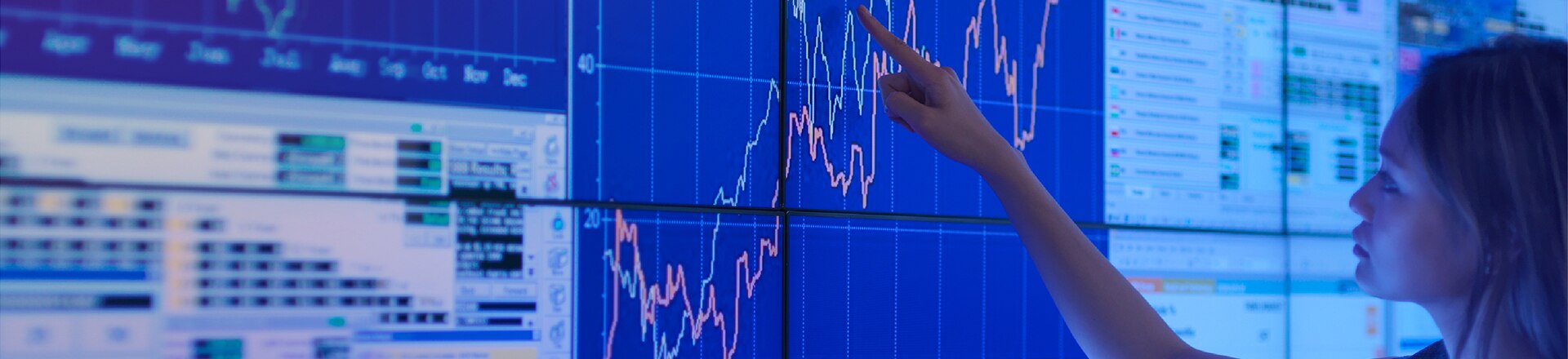 Woman tracing a graph line on a big screen