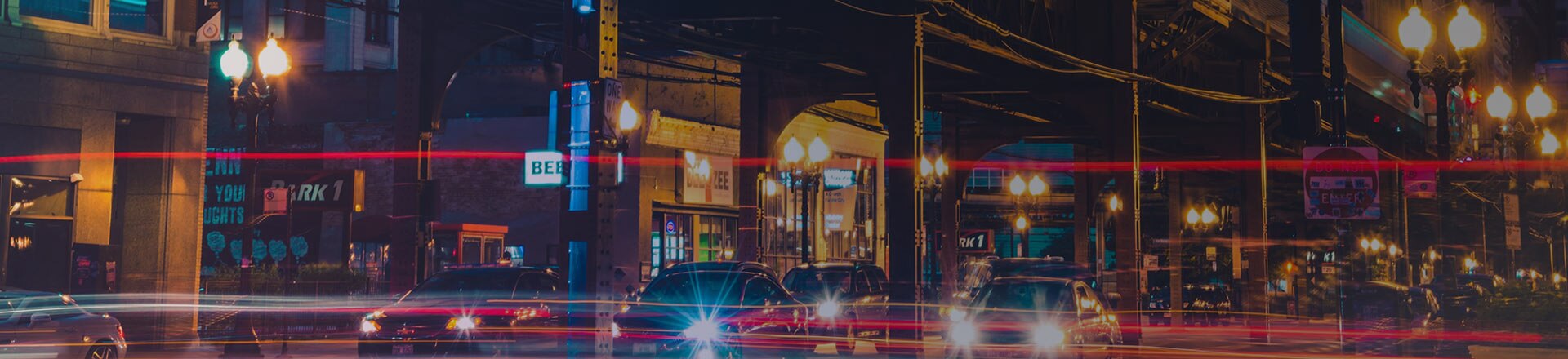 Cars with their headlights on on a city road