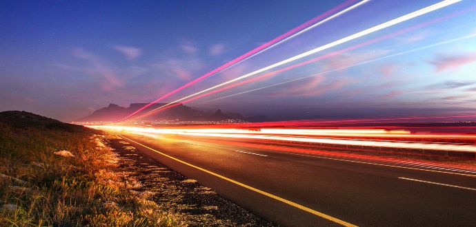 Trailing lights at dusk on an open road